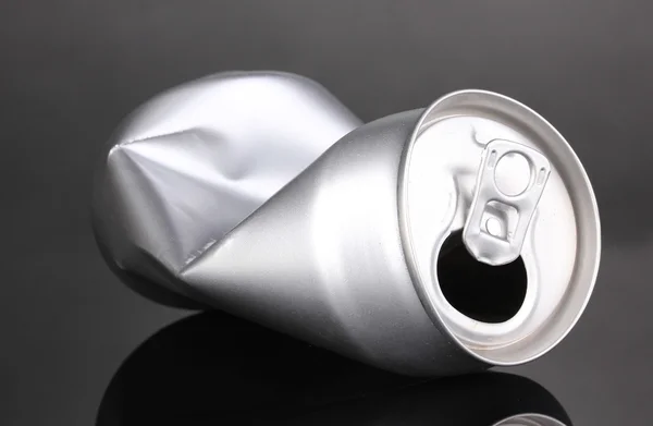 stock image Crumpled empty can on grey background