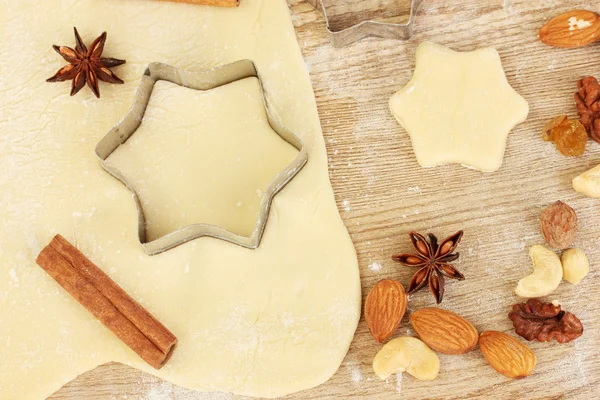 stock image Tins of cookies on the rolled out dough with herbs on a wooden table close-up