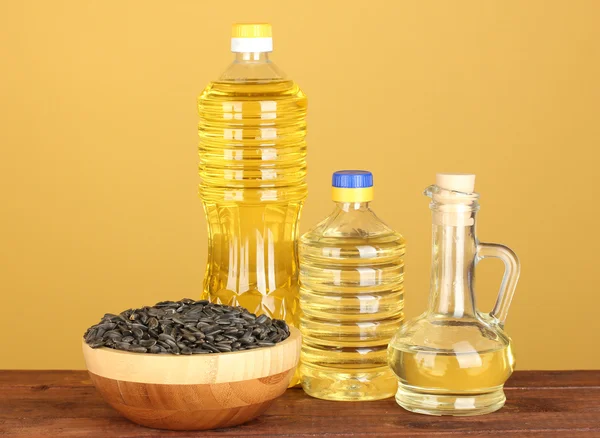 stock image Sunflower oil in bottles on yellow background close-up