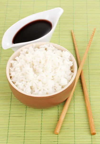 쌀과 대나무 매트에 젓가락의 그릇 — 스톡 사진
