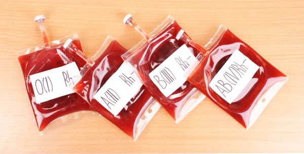 Bags of blood on wooden background — Stock Photo, Image