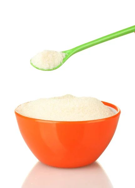 A colorful bowl full of white sugar with bright spoon on white background close-up — Stock Photo, Image