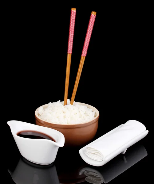 Bowl of rice and chopsticks isoalted on black — Stock Photo, Image