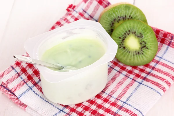 stock image Yogurt with kiwi on napkin on wooden background