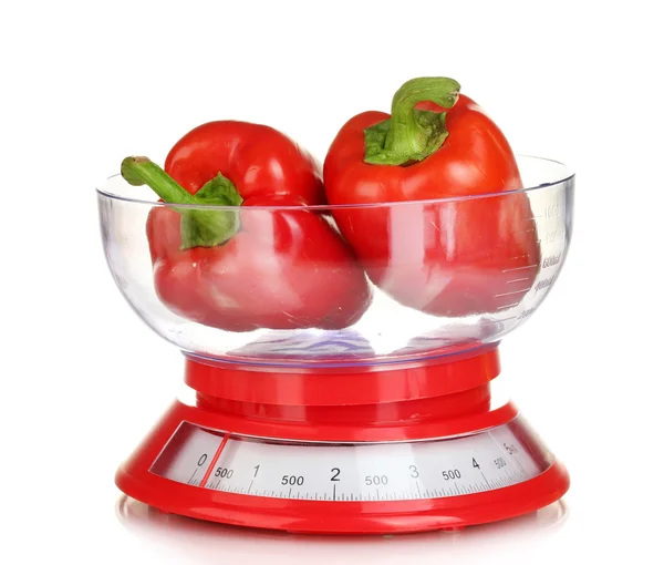 Fresh red peppers in a kitchen scales isolated on white — Stock Photo, Image