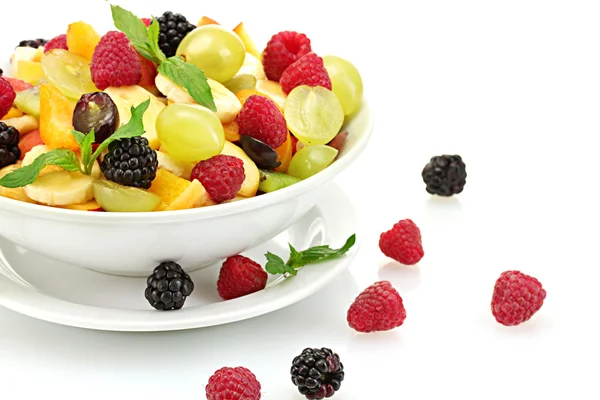 Fresh fruits salad in bowl and berries, isolated on white — Stock Photo, Image