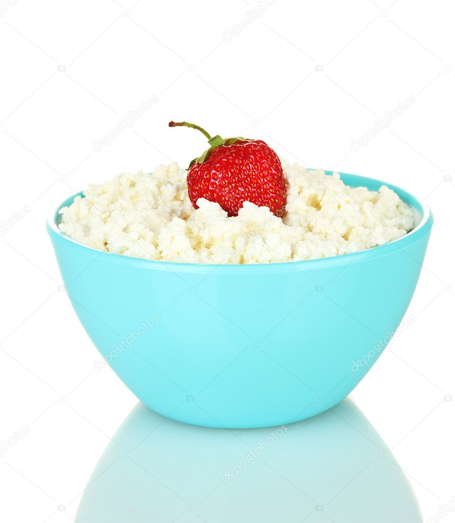 Cottage cheese with strawberry in blue bowl isolated on white