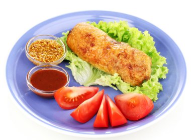 Tasty meat cutlet with garnish on plate isolated on white