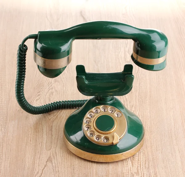 Retro telefon s plovoucí sluchátko na dřevěné pozadí — Stock fotografie
