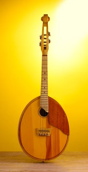 stock image Retro kobza- Ukrainian musical instrument on wooden table on yellow background