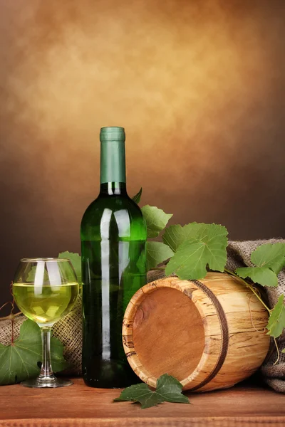 Пляшка чудового вина зі склом та октавою на дерев'яному столі на коричневому фоні — стокове фото