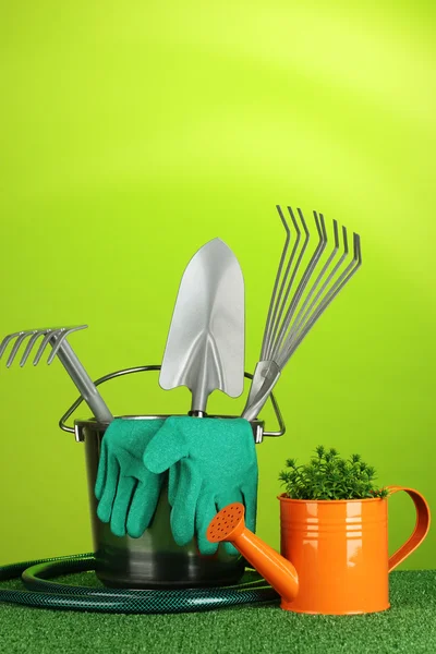 Garden tools on lawn on bright colorful background close-up Stock Picture