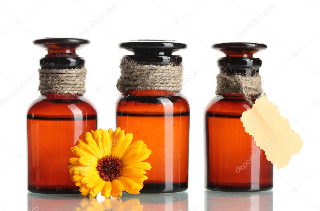 Medicine bottles and beautiful calendula flower, isolated on white