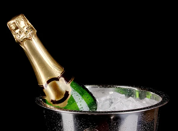 Bottle of champagne in bucket isolated on black — Stock Photo, Image