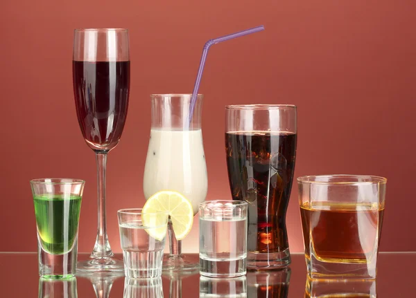 Een scala aan alcoholische dranken op rode achtergrond — Stockfoto