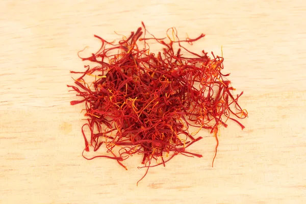 Stigmas of saffron on wooden background close-up — Stock Photo, Image