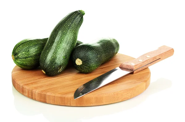 Fresh zucchini on chopping board isolated on white — Stock Photo, Image