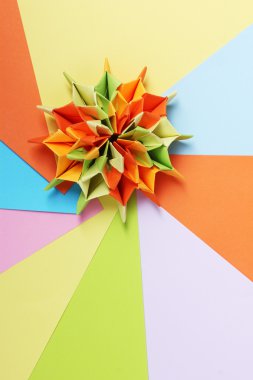 Colorfull origami on bright paper background clipart