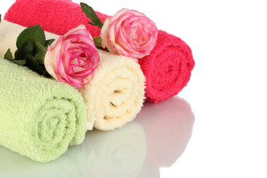 Bright towels and roses isolated on white