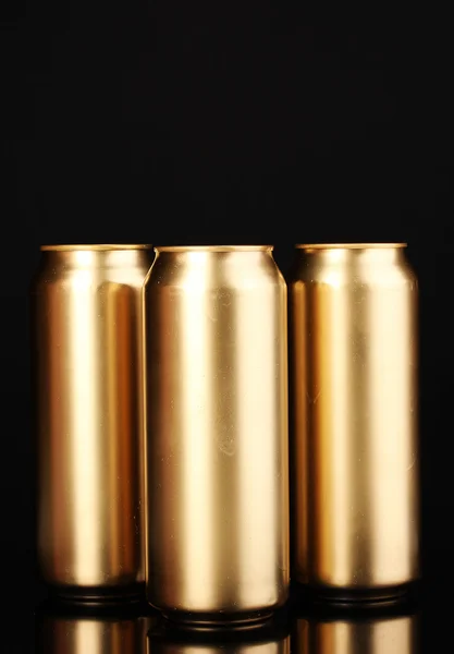 Golden cans isolated on black — Stock Photo, Image