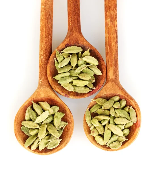 Green cardamom in wooden spoons on white background close-up — Stock Photo, Image