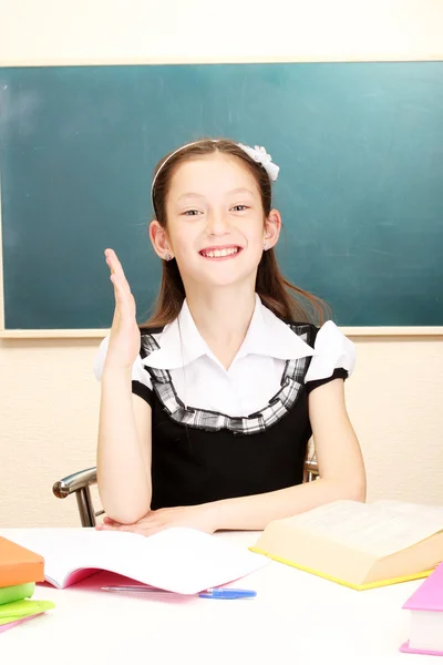 Beautiful little schoolgirl in classroom — Stock Photo, Image