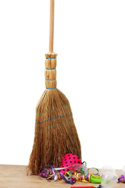 Broom sweep the trash after a party on white background close-up clipart