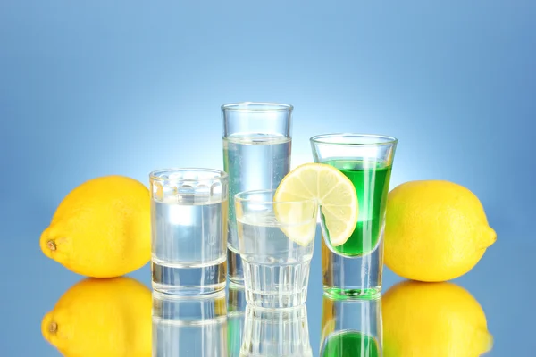 stock image A variety of alcoholic drinks on blue background