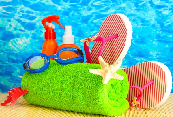 Bright beach accessories, on blue sea background — Stock Photo, Image