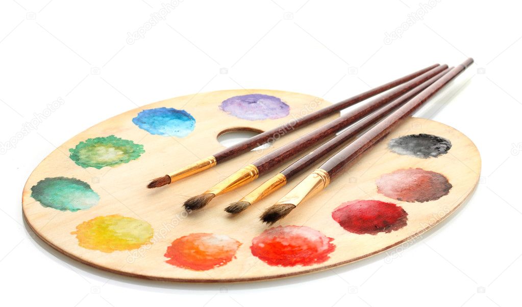 Wooden art palette with paint and brushes isolated on white