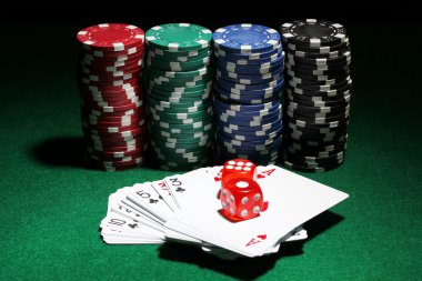 Cards, dices and chips for poker on green table clipart