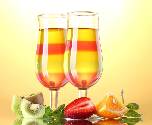 Фруктовий желе в окулярах і фруктах на жовтому фоні — стокове фото