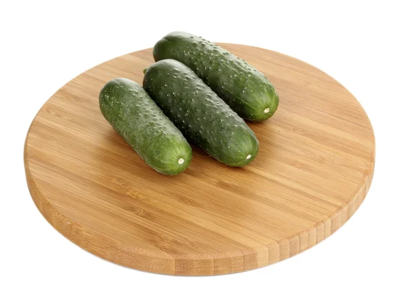 Fresh cucumbers on wooden board isolated on white — Stock Photo, Image