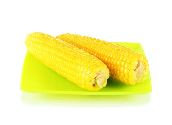 Boiled corn isolated on white on the green plate — Stock Photo, Image