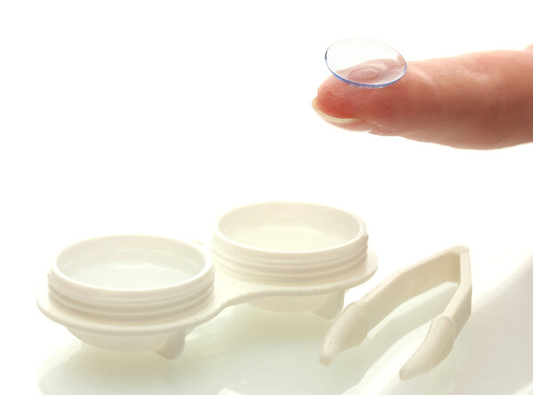 Contact lenses in containers and tweezers, isolted on white