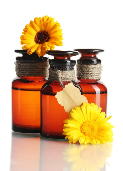Medicine bottles and beautiful calendula flowers, isolated on white — Stock Photo, Image