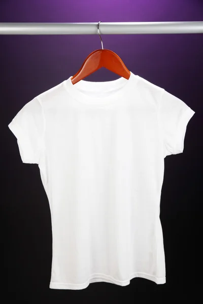 White t-shirt on hanger on purple background — Stock Photo, Image