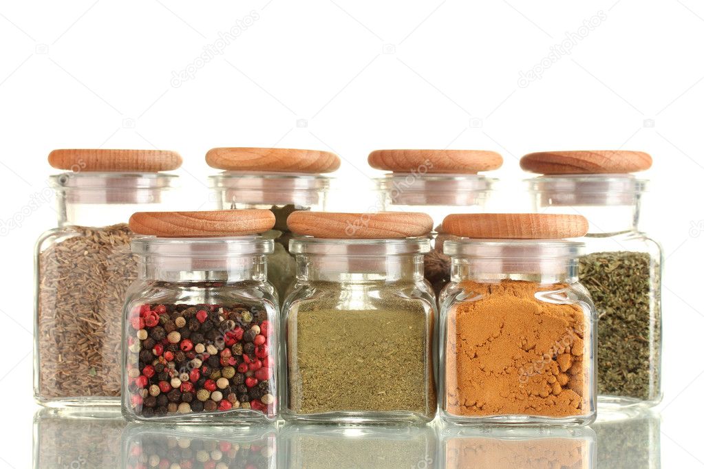 Powder spices in glass jars isolated on white