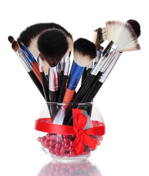 Make-up brushes in glass vase isolated on white — Stock Photo, Image