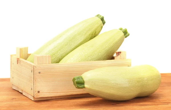 Squash in a box on wooden table on white background close-up — Stock Photo, Image