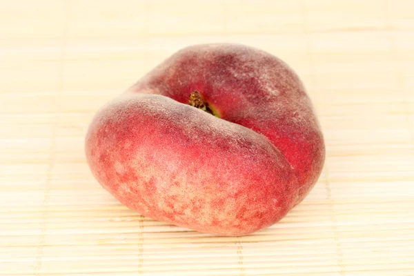 Ripe fig peach on bamboo mat — Stock Photo, Image