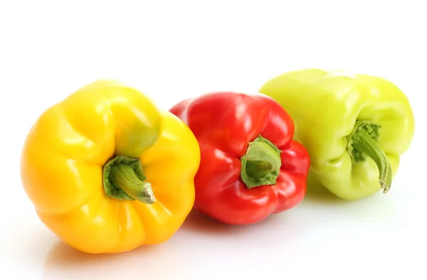 Fresh yellow, red and green bell peppers isolated on white — Stock Photo, Image