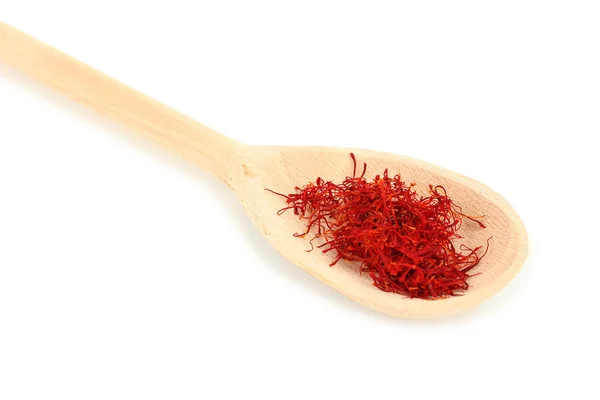 Stigmas of saffron in wooden spoon on white background close-up — Stock Photo, Image