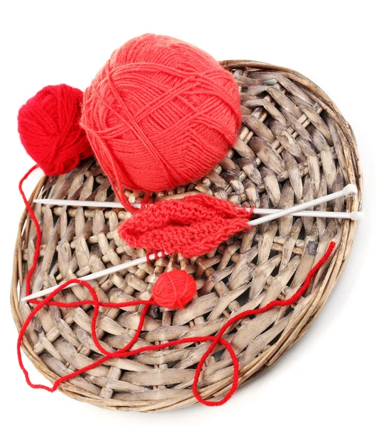 Red knittings yarns on the wicker cradle close-up isolated on white — Stock Photo, Image