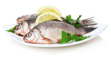 Fresh fishes with lemon and parsley on plate isolated on white clipart