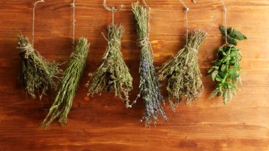 Dried herbs, on wooden background clipart