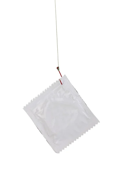 Preservativo no gancho isolado no branco — Fotografia de Stock