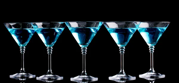 Blue cocktail in martini glasses isolated on black — Stock Photo, Image