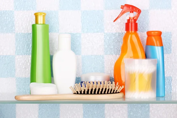 Shelf with cosmetics and toiletries in bathroom — Stock Photo, Image