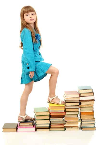 Маленька дівчинка з книгами ізольована на білому — стокове фото